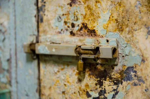 old latch is locking pale door