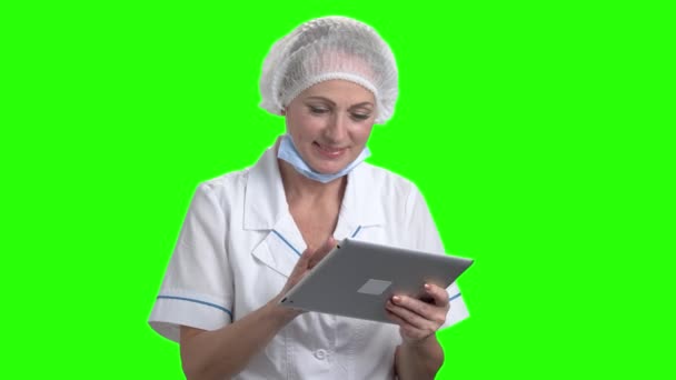 Caucasian doctor with digital tablet on green screen. — Stock Video