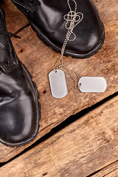 Military army boots and dog tags.
