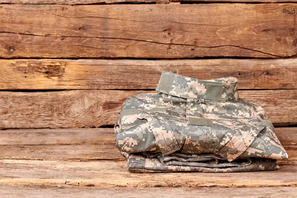 Neatly folded military camoflage uniform.