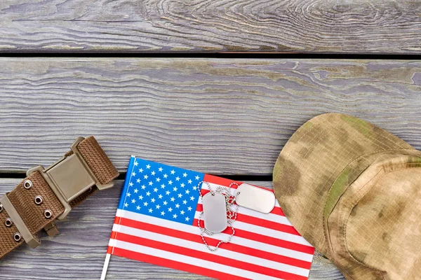 American flag, nylon strap, dog tags and military cap.