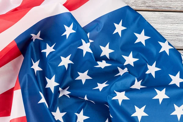 Close up crumpled flag of USA on wood. — Stock Photo, Image