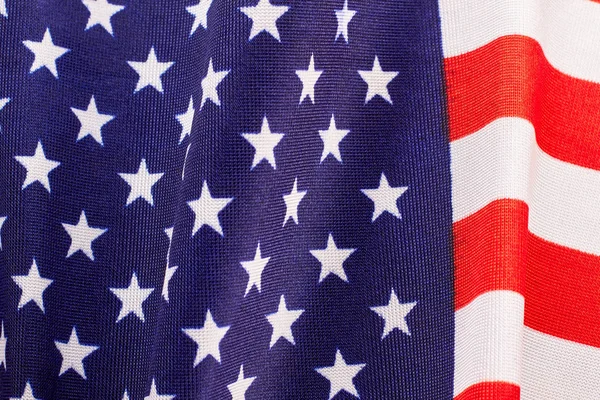 Stars and stripes fabric flag background. Close up cotton flag of United States of America. USA flag wallpaper.