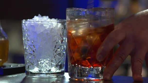 Stirring brandy with ice, close up. — Stock Video