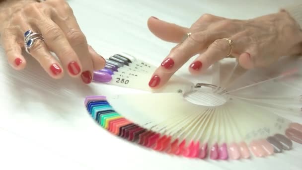 Female manicured hands and nail samples. — Stock Video