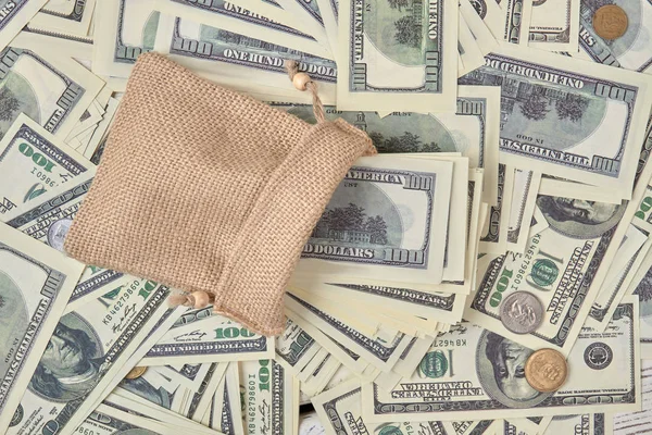 Wiele banknotów dolarowych w worek. — Zdjęcie stockowe