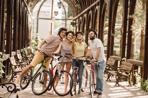 Group of cyclists taking selfie with monopod.