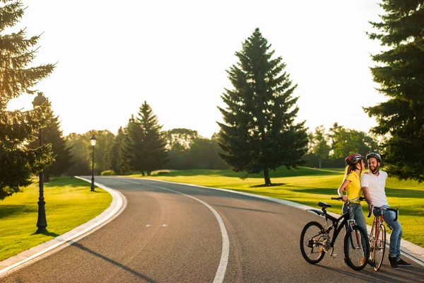 Joven hombre y mujer teniendo un paseo en bicicleta al aire libre . — Foto de Stock