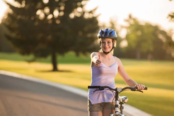 Beautiful girl riding on bike outdoor.