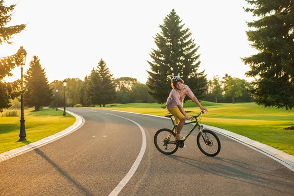 stock image Male student enjoying riding bike.