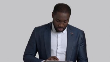 Kendine güvenen işadamı gri arka plan üzerine konuşma.