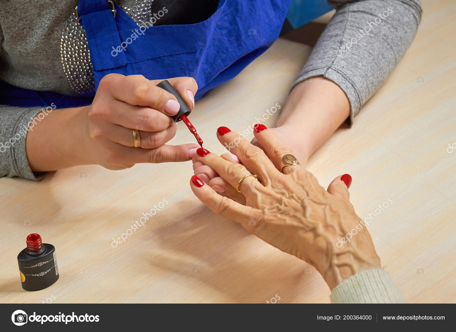 Esteticista aplicando verniz vermelho para unhas de mulher . fotos, imagens  de © Denisfilm #200364000