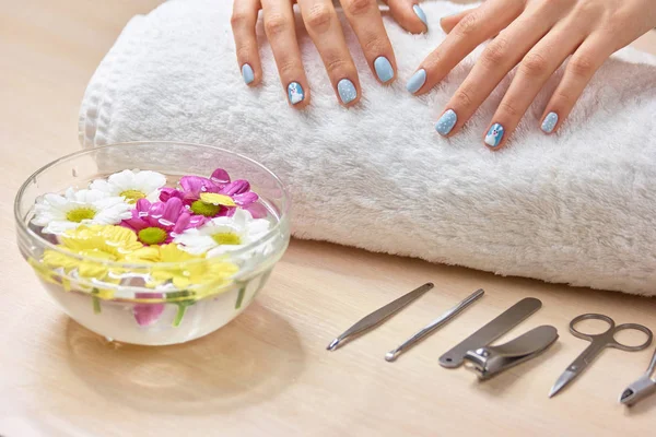 Hands of young woman on towel.