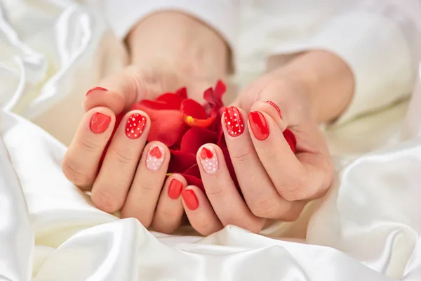 Rose petals in female hands.