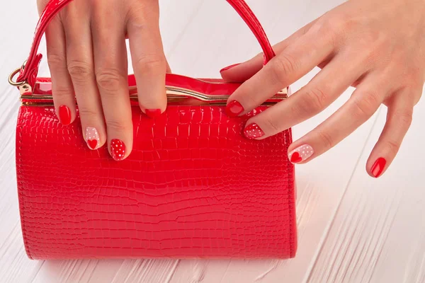 Red manicure and red clutch. — Stock Photo, Image