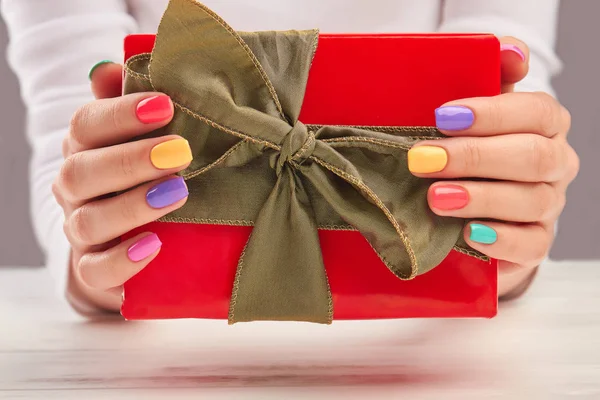 Woman hands holding gift box.