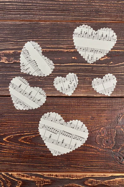 Paper hearts with music notes, top view.