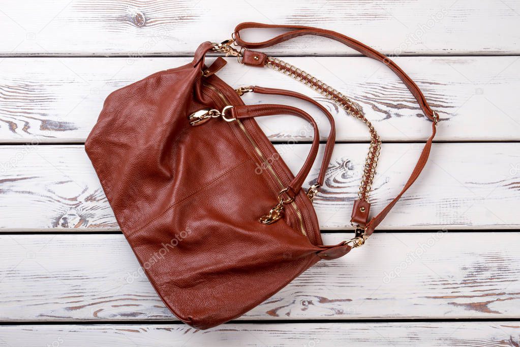 Flat lay brown leather purse.