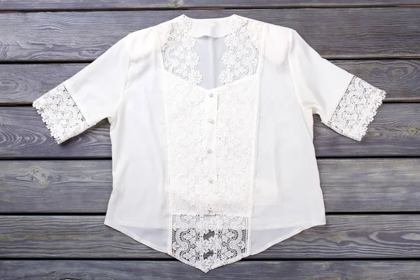 White lace blouse top view.