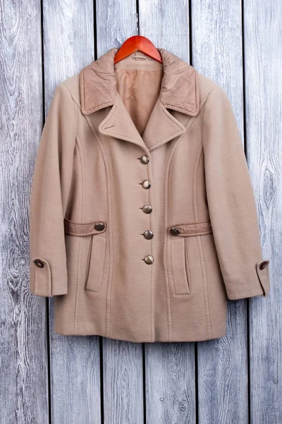 Flat lay brown winter coat.
