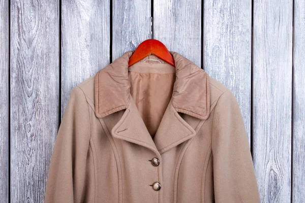 Brown coat on hanger, close up. — Stock Photo, Image