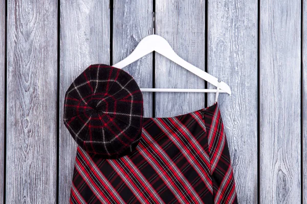 Checkered hat, skirt and hanger.
