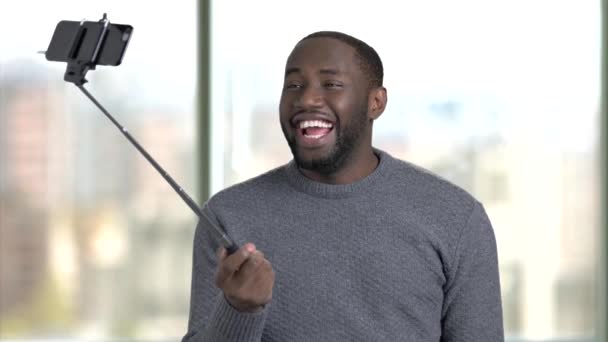 Black african man taking selfie using selfie stick. — Stock Video