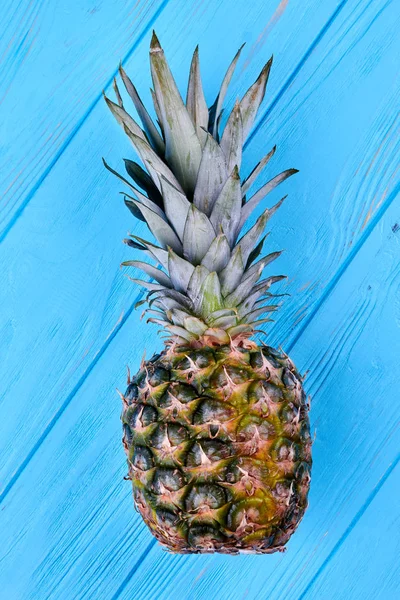 Hawaiian pineapple on blue wooden background.