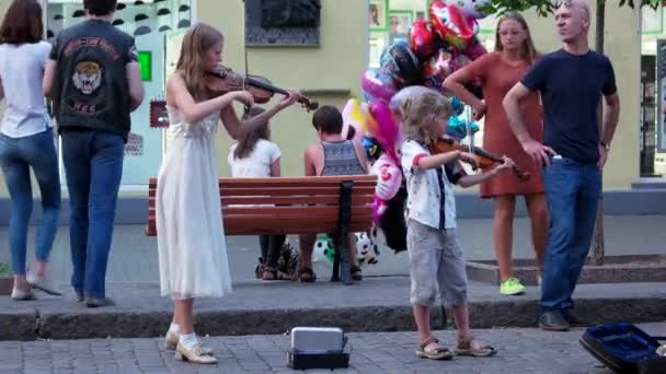 Las chicas tocan el violín en la calle . — Vídeo de stock