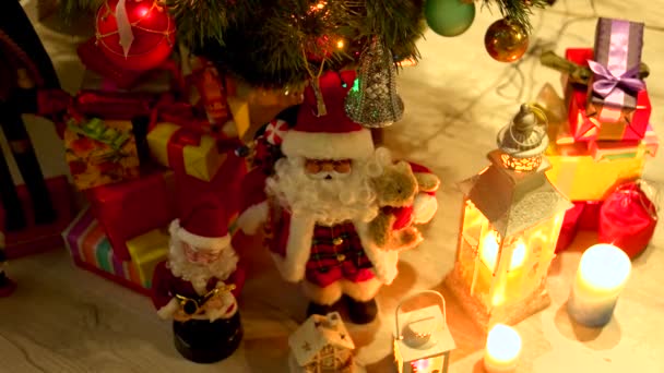 Christmas gifts and lights under Christmas tree. — Stock Video