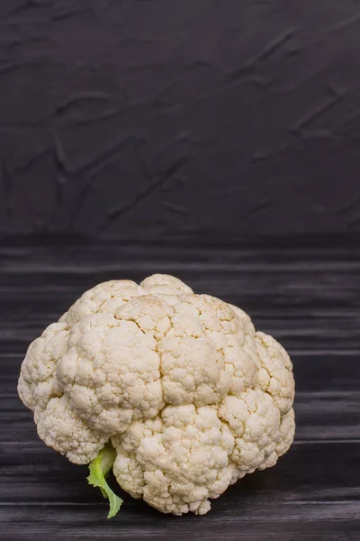 Head of raw cauliflower on black background. — Stock Photo, Image