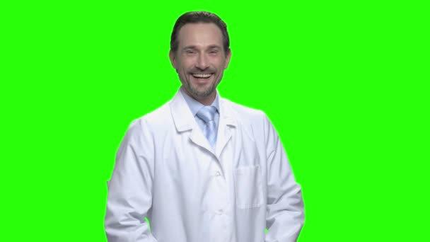 Cheerful laughing male doctor in white coat. — Stock Video