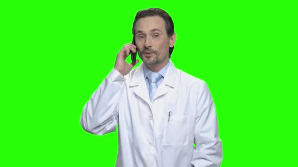 Θετική χαμογελώντας αρσενικό γιατρό του μιλώντας στο τηλέφωνο. — Αρχείο Βίντεο