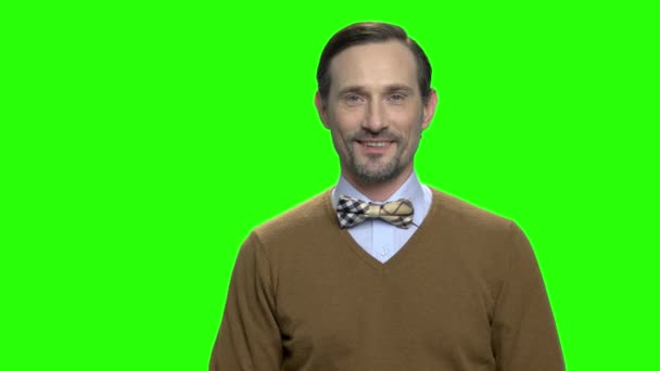 Friendly caucasian man with brown sweater and bow tie. — Stock Video