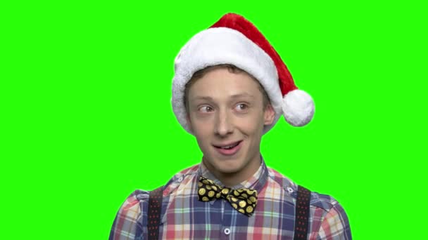 Positive thoughtful teenager in christmas hat. — Stock Video