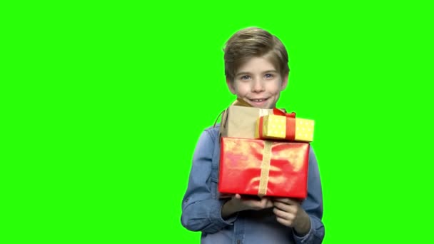 Portrait of little boy in denim jacket with gift boxes. — Stock Video