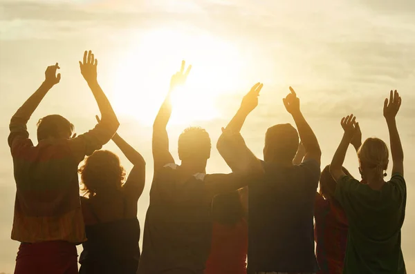 Happy people put hands up, back view. — Stok Foto