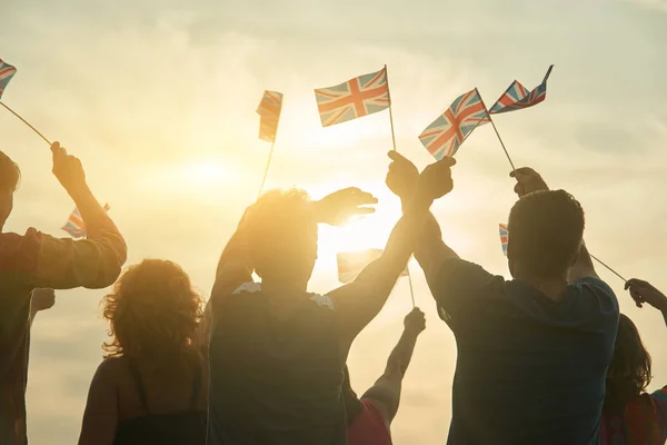 Waving UK flags.