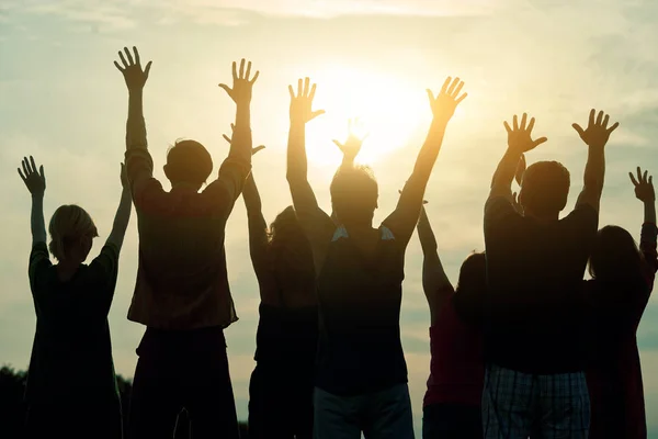 People raising hands up, rear view. Royalty Free Stock Images