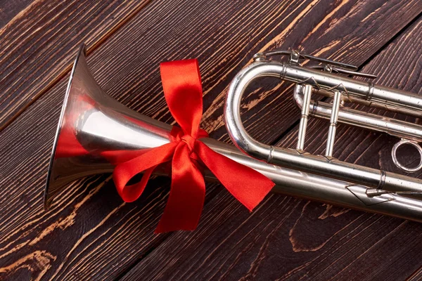 Trumpet with red bow. — Stock Photo, Image