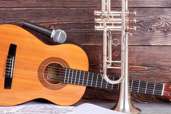 Acustic guitar, microphone and trumpet.