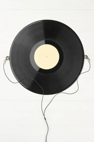 Vinyl record and earphones, top view. — Stock Photo, Image