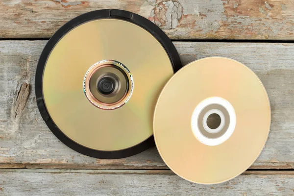 DVD discs on old wooden background. — Stock Photo, Image