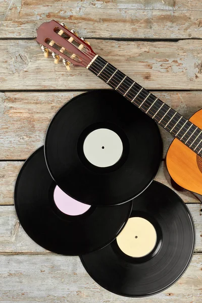 Vinyl records and wooden guitar. — Stock Photo, Image