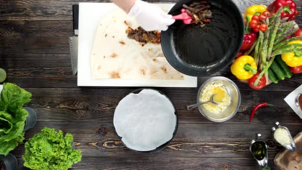 Mains de chef faisant burrito .