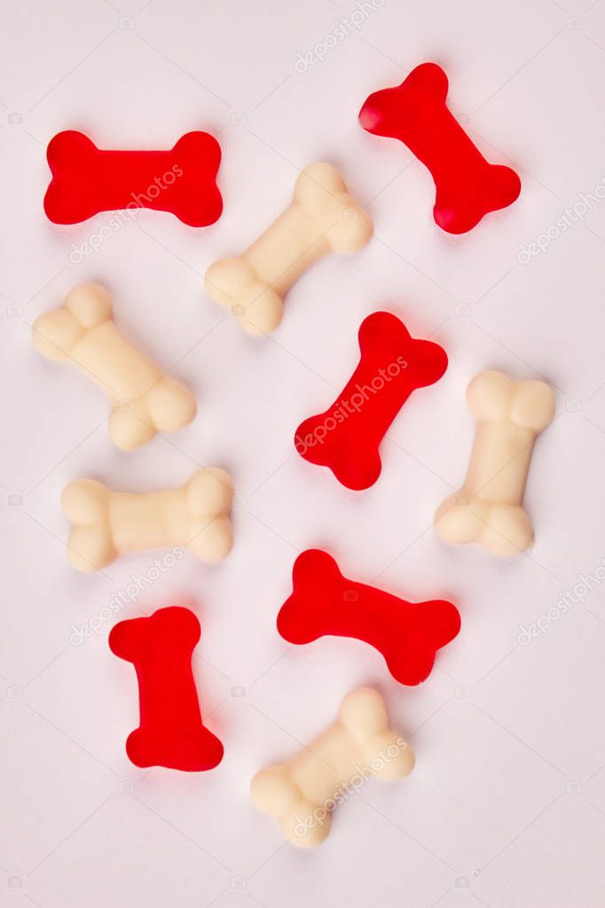 Red and white gummy candies in shape of bones.