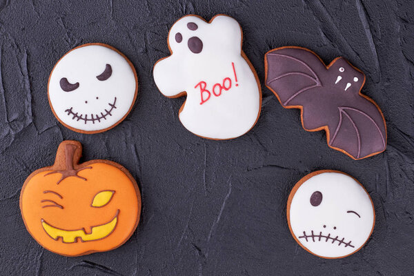Various Halloween biscuits on black background.