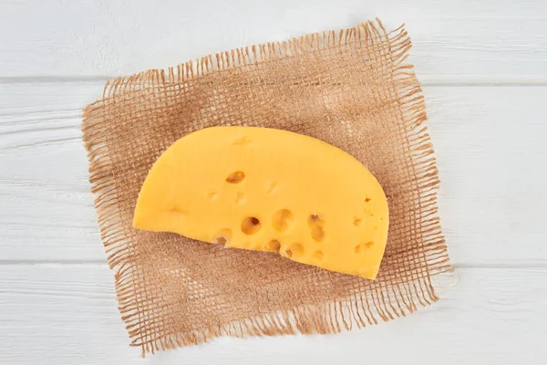 Chunk of cheese on rustic napkin. — Stock Photo, Image