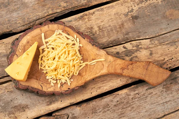 Cheese on natural wooden board. — Stock Photo, Image