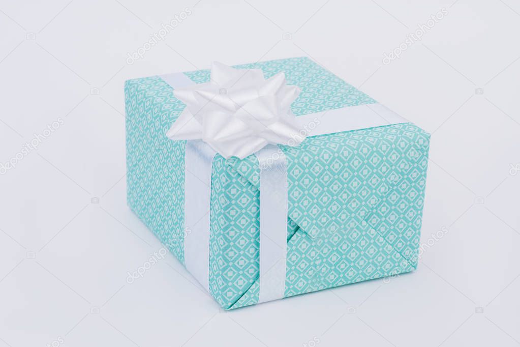Christmas gift box with white bow isolated.